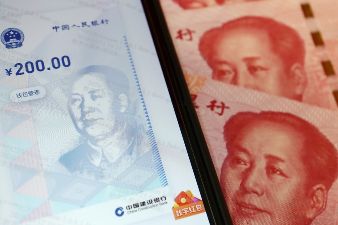 China's official app for its digital yuan is seen displayed on a smartphone next to 100-yuan banknotes on October 16. Photo: Reuters