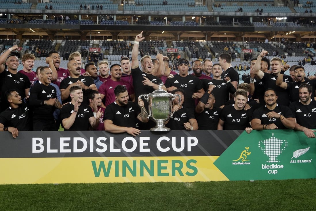 New Zealand captain Sam Cane (centre) and teammates celebrate with the Bledisloe Cup after beating Australia. Photo: AP