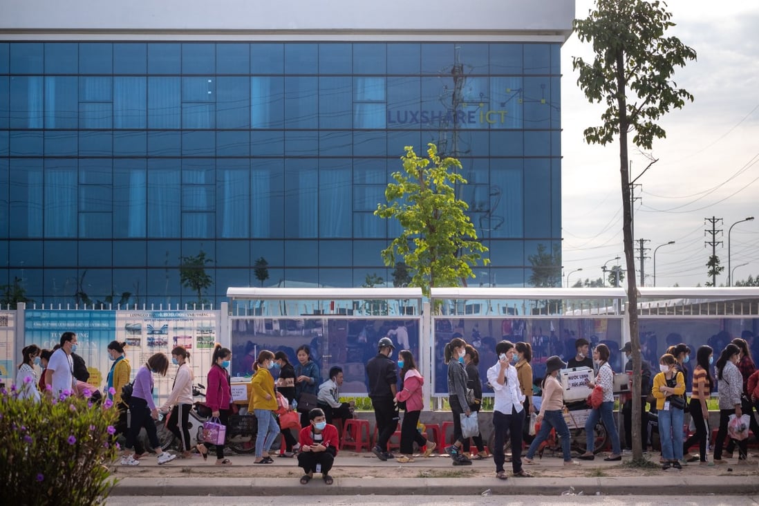 Commuters walk past a China Luxshare Precision Industry Company factory in Vietnam’s Bac Giang province. The US is opening an investigation into whether Vietnam has been undervaluing its currency and harming US commerce. Photo: Bloomberg