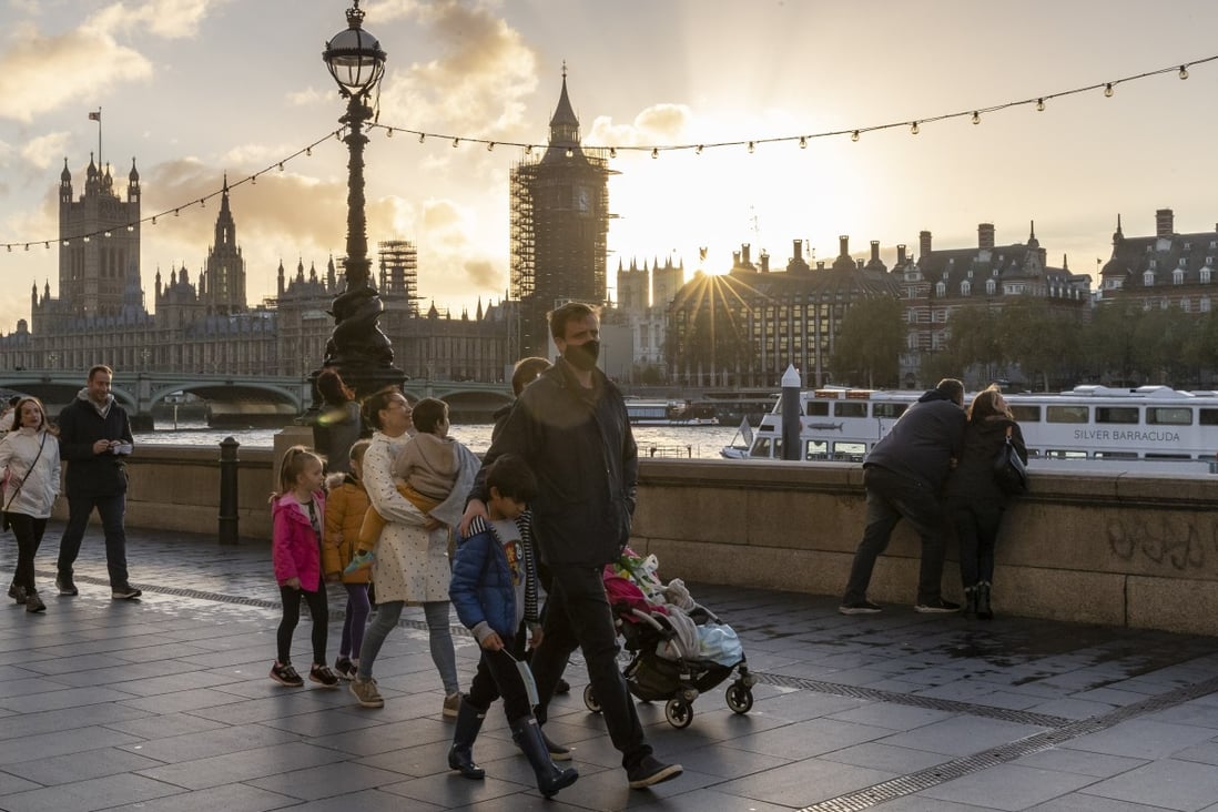People walk along the River Thames in London, a day after Britain announced a month-long lockdown to quell a resurgence of coronavirus infections. Photo: Xinhua