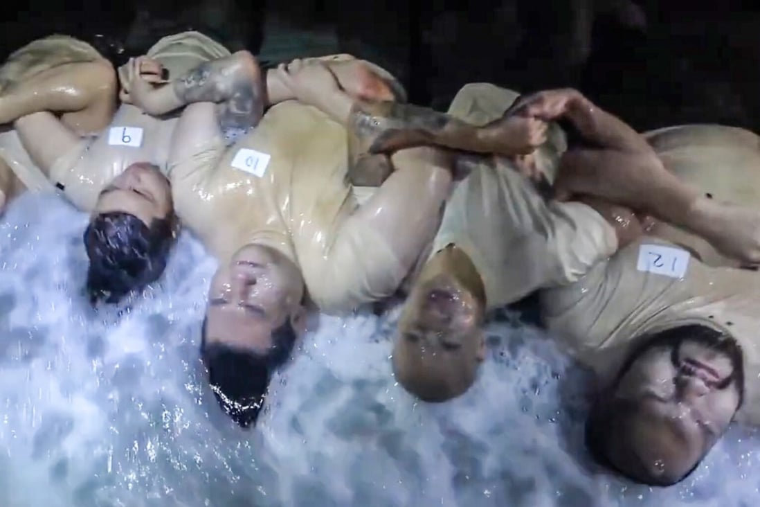 Contestants lying down and facing icy waves at midnight hours during season two's premiere. Photo: Handout