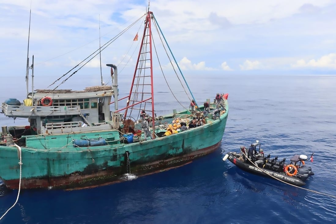 Indonesian coast guard personnel detain a Vietnamese fishing vessel near the Natuna islands in July. Photo: AFP