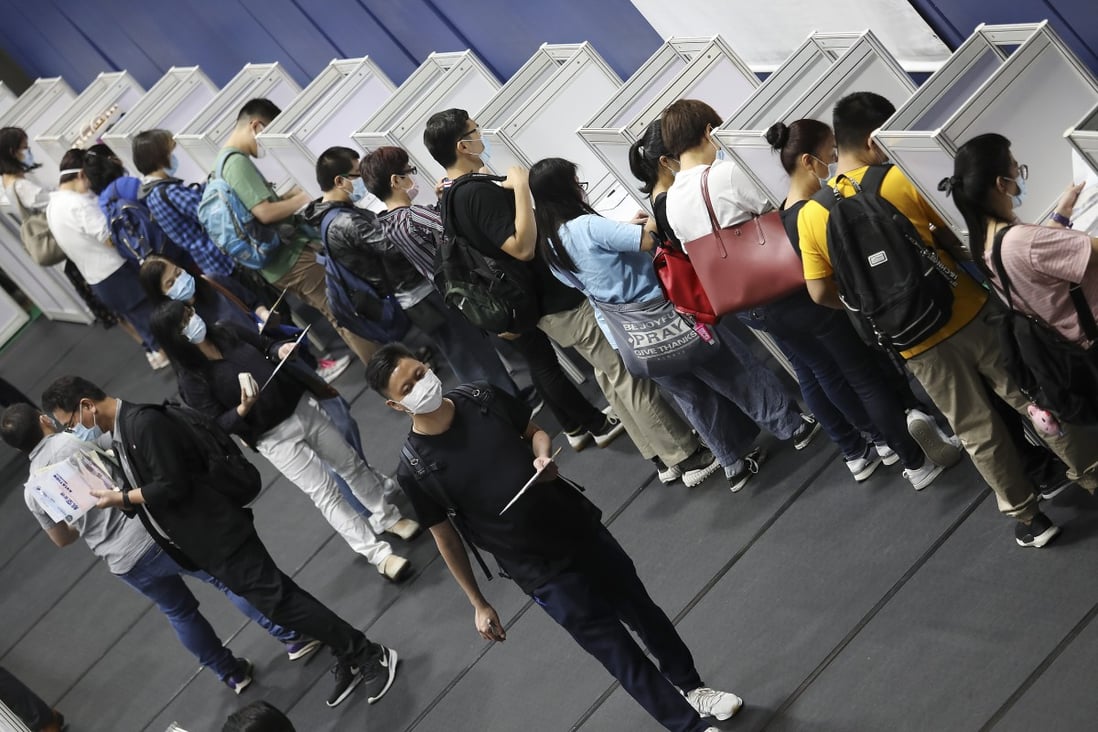 Job seekers fill out application forms at a large-scale employment fair held by the Labour Department at Southorn Stadium in Wan Chai on October 28. Photo: Nora Tam