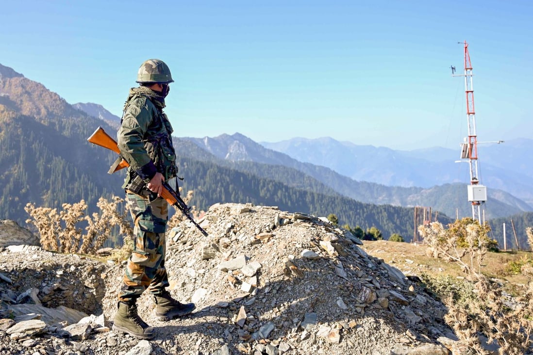 An Indian soldier stands guard on a mountain pass near the Line of Control that separates the country from China. Photo: AFP