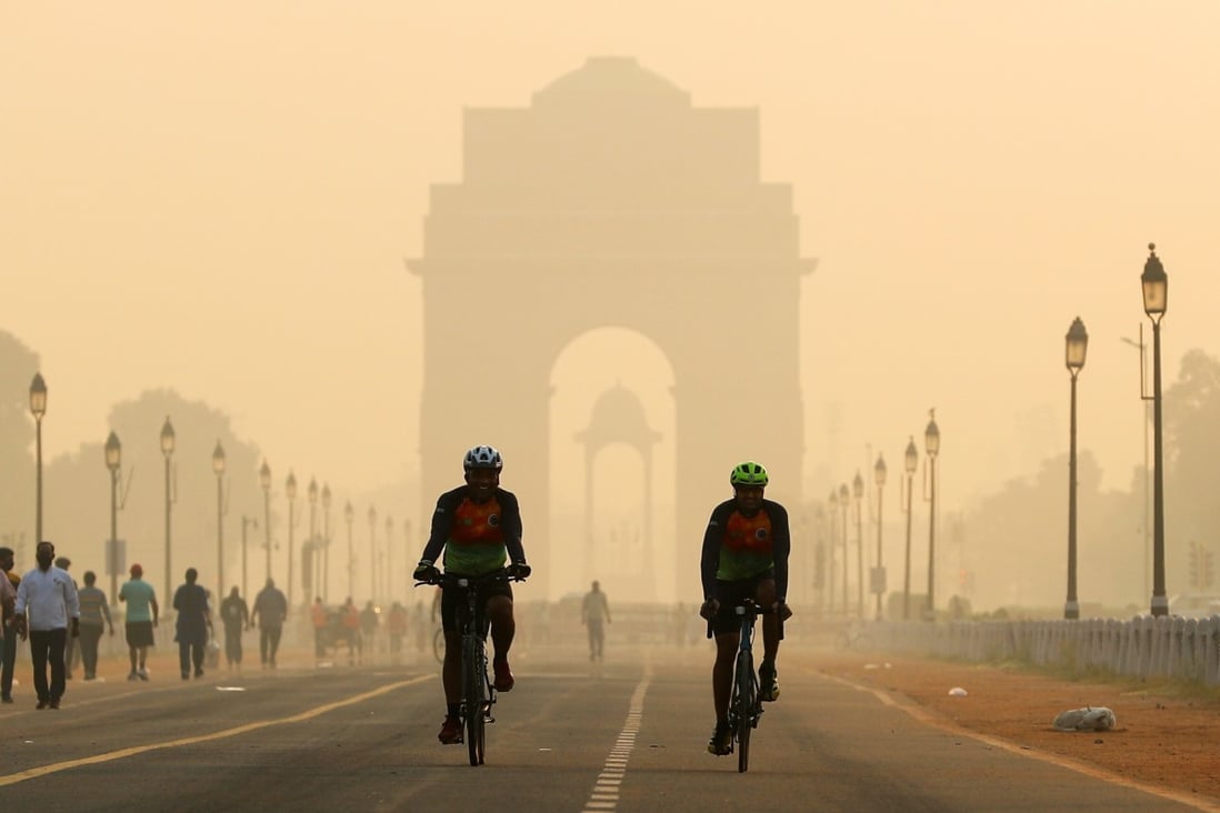 Men ride their bikes in front of the India Gate shrouded in smog in New Delhi on October 24. India’s government has announced ambitious plans to clean up the air in the capital and other cities, but it has produced little in terms of actionable plans. Photo: Reuters