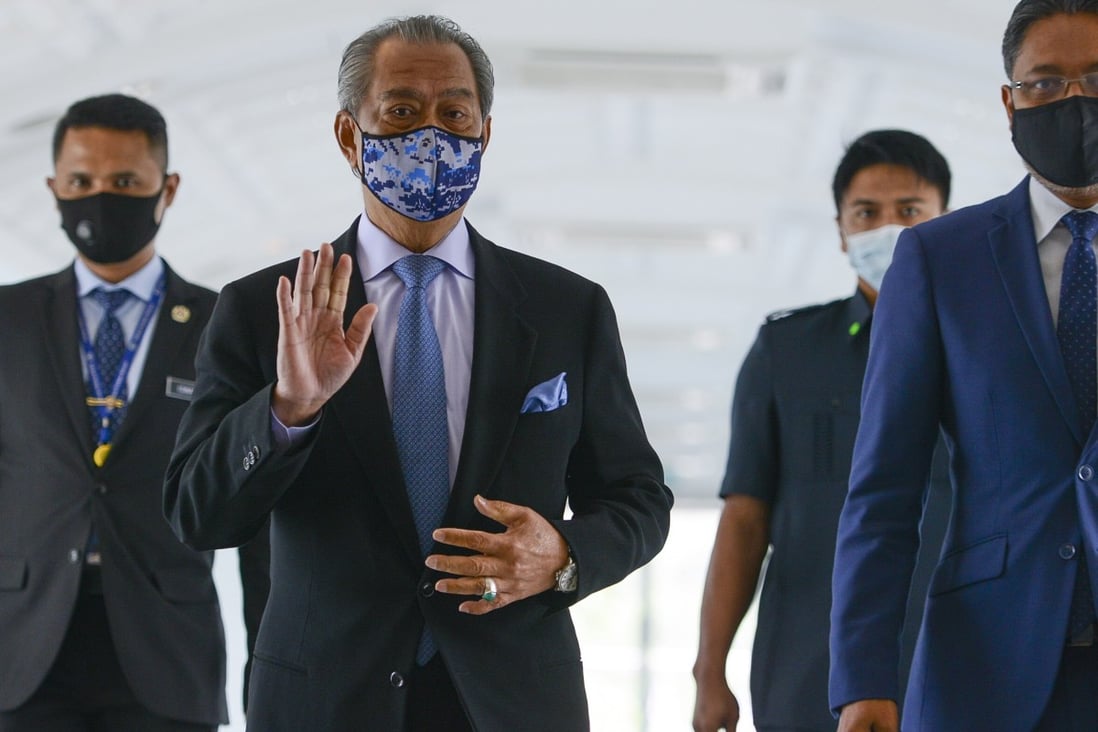 Malaysia’s Prime Minister Muhyiddin Yassin waves as he arrives for a meeting at the parliament building in Kuala Lumpur on Monday. Photo: EPA