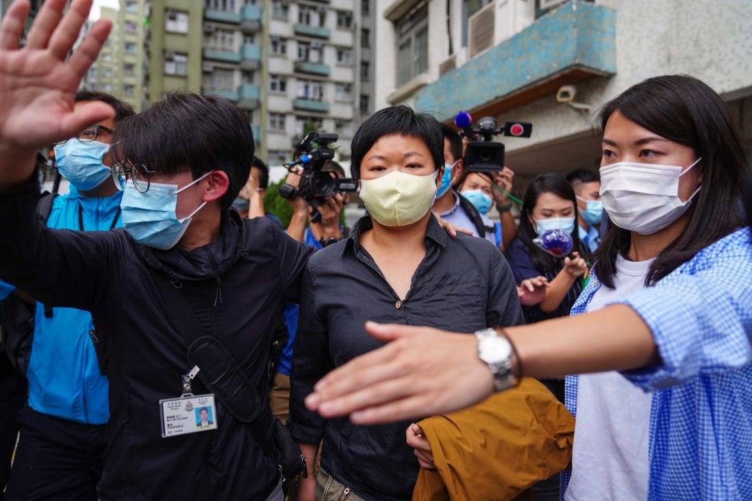 RTHK contributor Choy Yuk-ling is led from her home by police. Photo: Sam Tsang