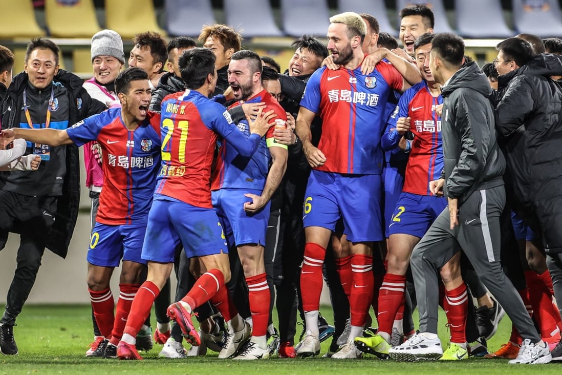Qingdao Huanghai players celebrate after beating Wuhan Zall in a penalty shoot-out to avoid relegation in the Chinese Super League. Photo: Xinhua