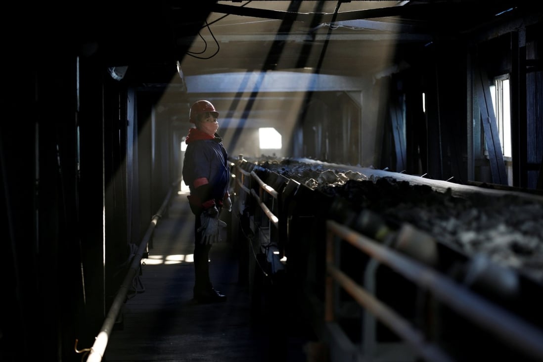 A worker inspects a conveyor belt carrying coal at a coal coking plant in Yuncheng in China’s Shanxi province on January 31, 2018. Photo: Reuters