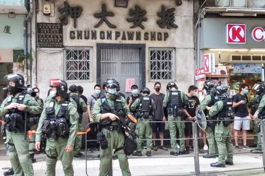 Police pull people wearing black to one side of Johnston Road in Wan Chai in an attempt to prevent protests on National Day, October 1. Photo: Jack Lau