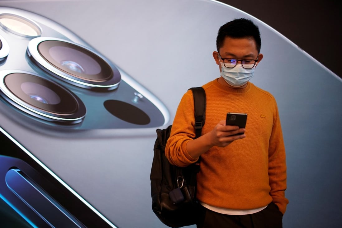 A man wears a face mask while waiting at an Apple Store before the new 5G iPhone 12 goes on sale as the coronavirus outbreak continues in Shanghai on October 23. Photo: Reuters