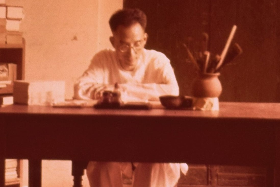 Chinese scholar Xu Fancheng pictured sat at a desk in his house in Pondicherry. Photo: Handout / Xu Fancheng Culture Study Centre
