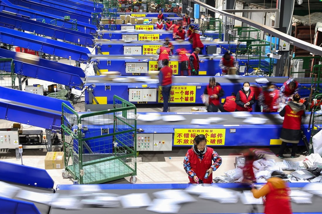 Workers sort packages after the Singles’ Day shopping festival at a delivery company in Hengyang, in China’s central Hunan province, on November 12, 2018. Photo: AFP