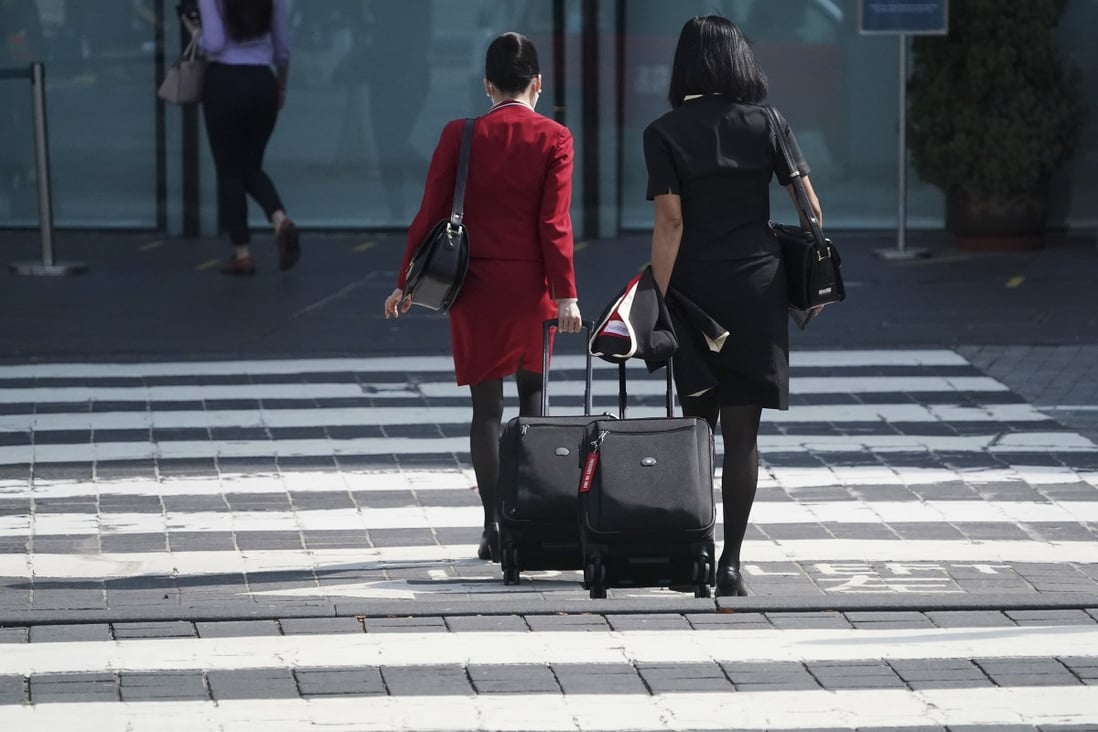 Cathay Pacific employees wheel their luggage towards the company’s headquarters at Chek Lap Kok on October 21. Photo: Felix Wong