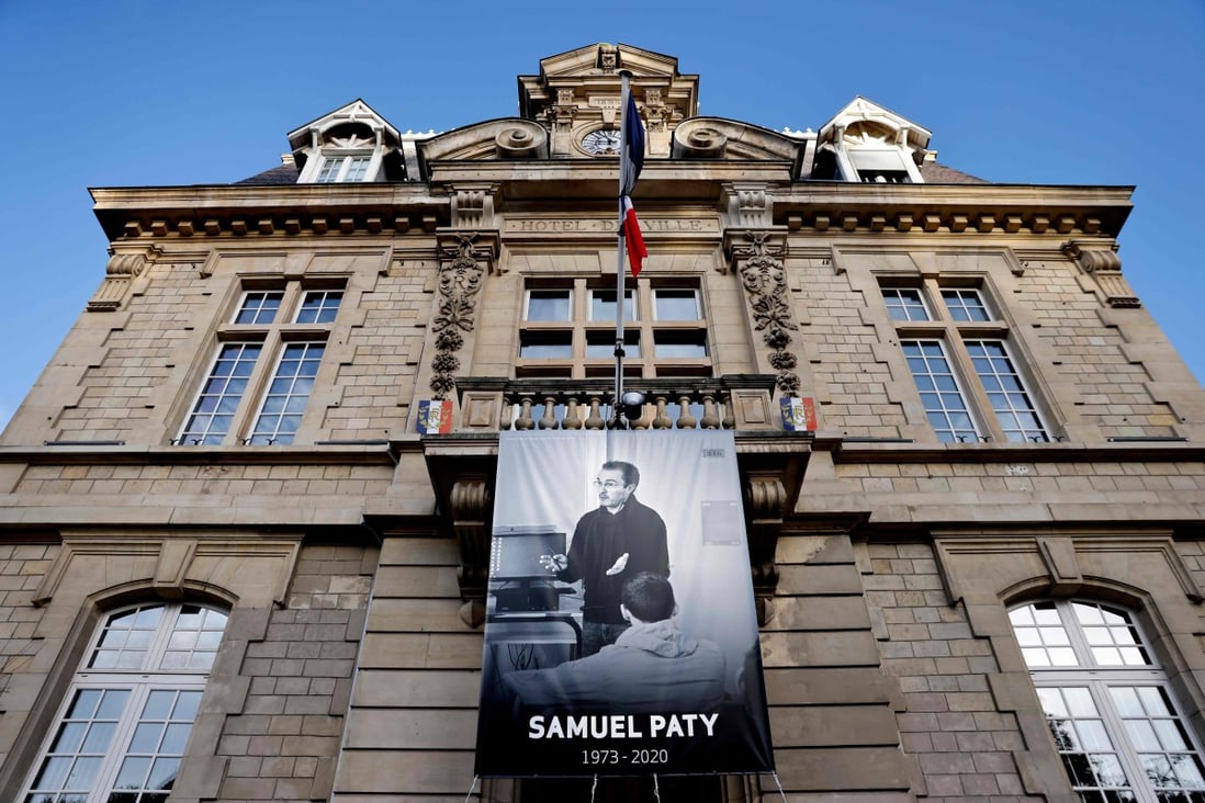 A poster depicting French teacher Samuel Paty placed on the facade of the city hall in Conflans-Sainte-Honorine, near Paris. Photo: AFP