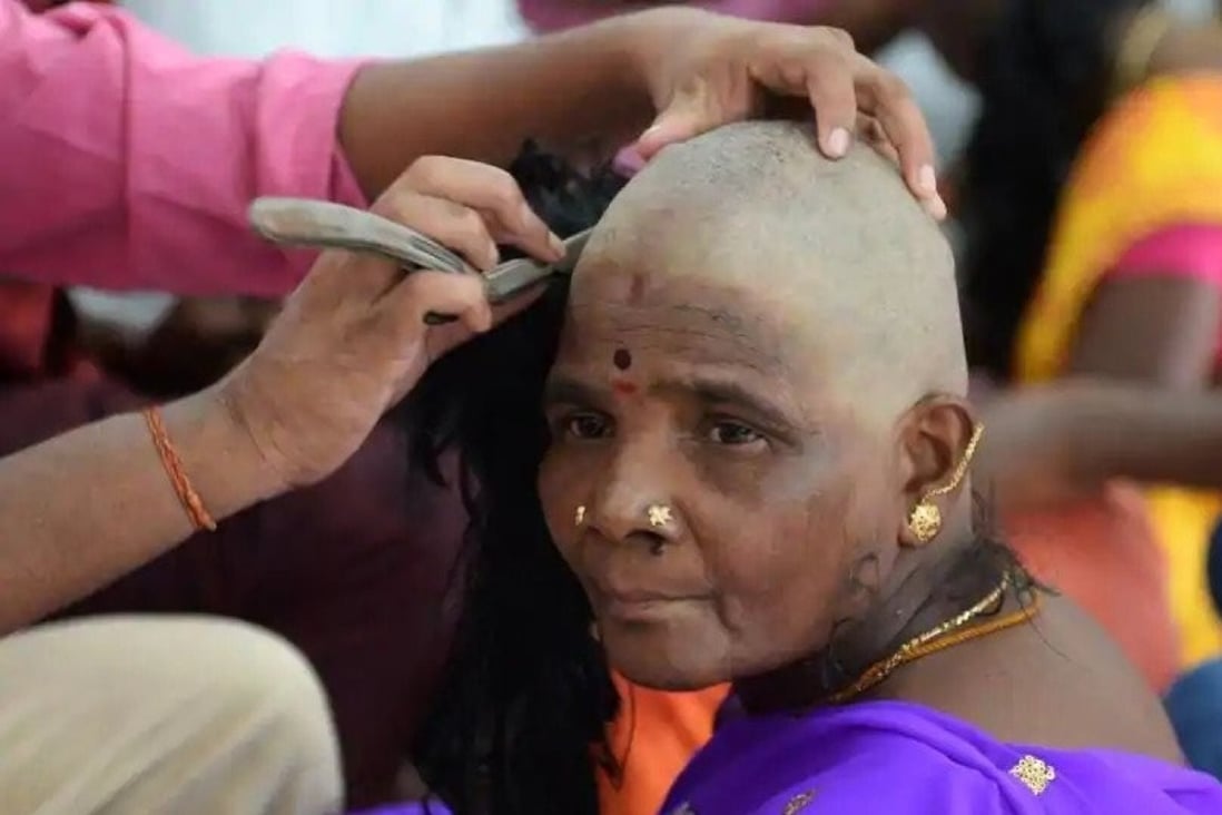 A woman at a temple in southern India getting her hair sheared in an act of veneration. Photo: Raj Hair International Pvt Ltd