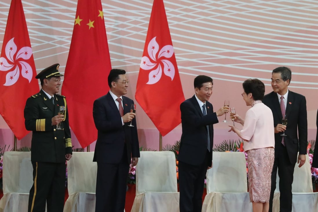 Luo Huining, director of the liaison office, clinks glasses with Carrie Lam as Chen Daoxiang (left), head of the PLA Hong Kong garrison, Xie Feng, the foreign ministry‘s representative in the city, and former chief executive Leung Chun-ying look on during the flag-raising ceremony on the 23rd anniversary of the establishment of the Hong Kong special administrative region, at Golden Bauhinia Square in Wan Chai on July 1. Photo: K.Y. Cheng