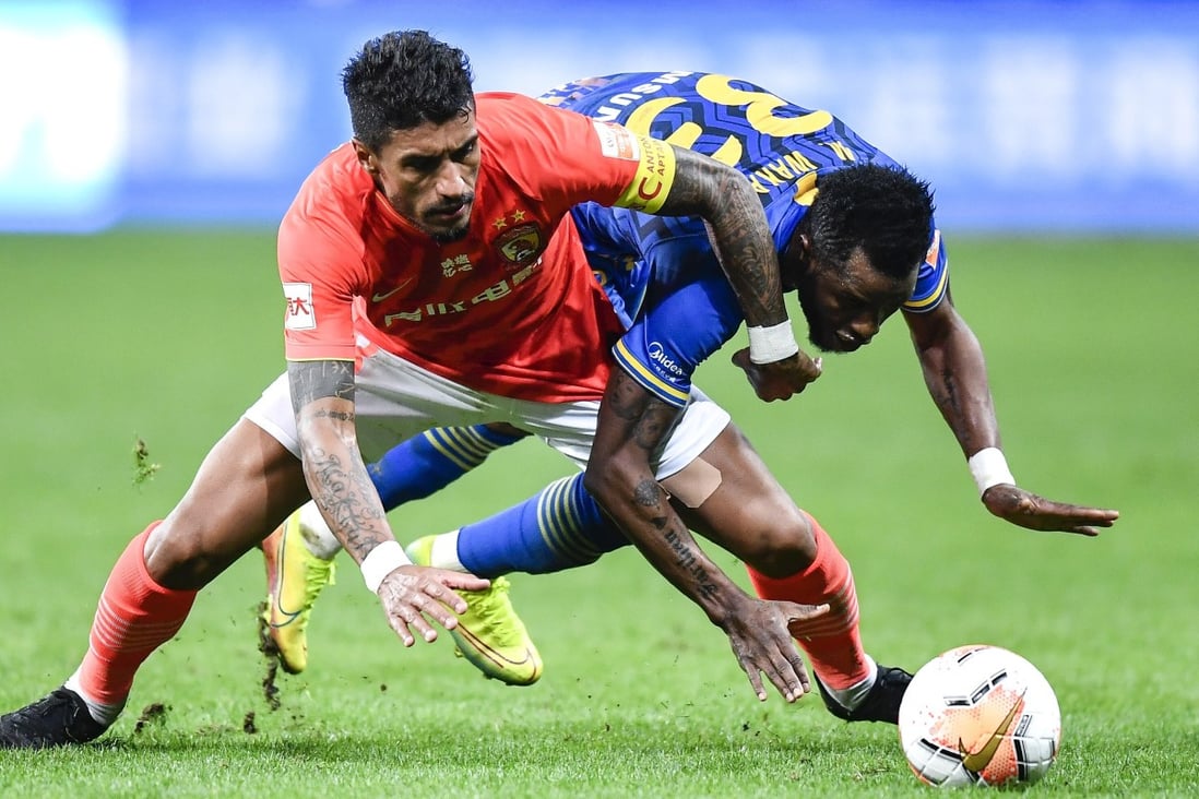 Paulinho of Guangzhou Evergrande battles for the ball with Jiangsu Suning’s Alhassan Wakaso in the first leg of the Chinese Super League title decider. Photo: Xinhua