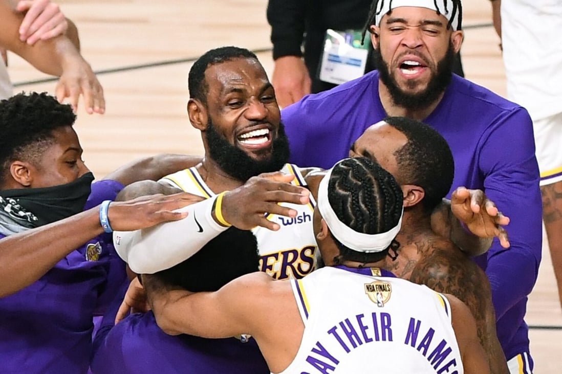 Los Angeles Lakers players including LeBron James (centre) celebrate winning the 2020 NBA Championship after defeating the Miami Heat. James has indicated the team will visit the White House under Joe Biden. Photo: Wally Skalij/Los Angeles Times/TNS