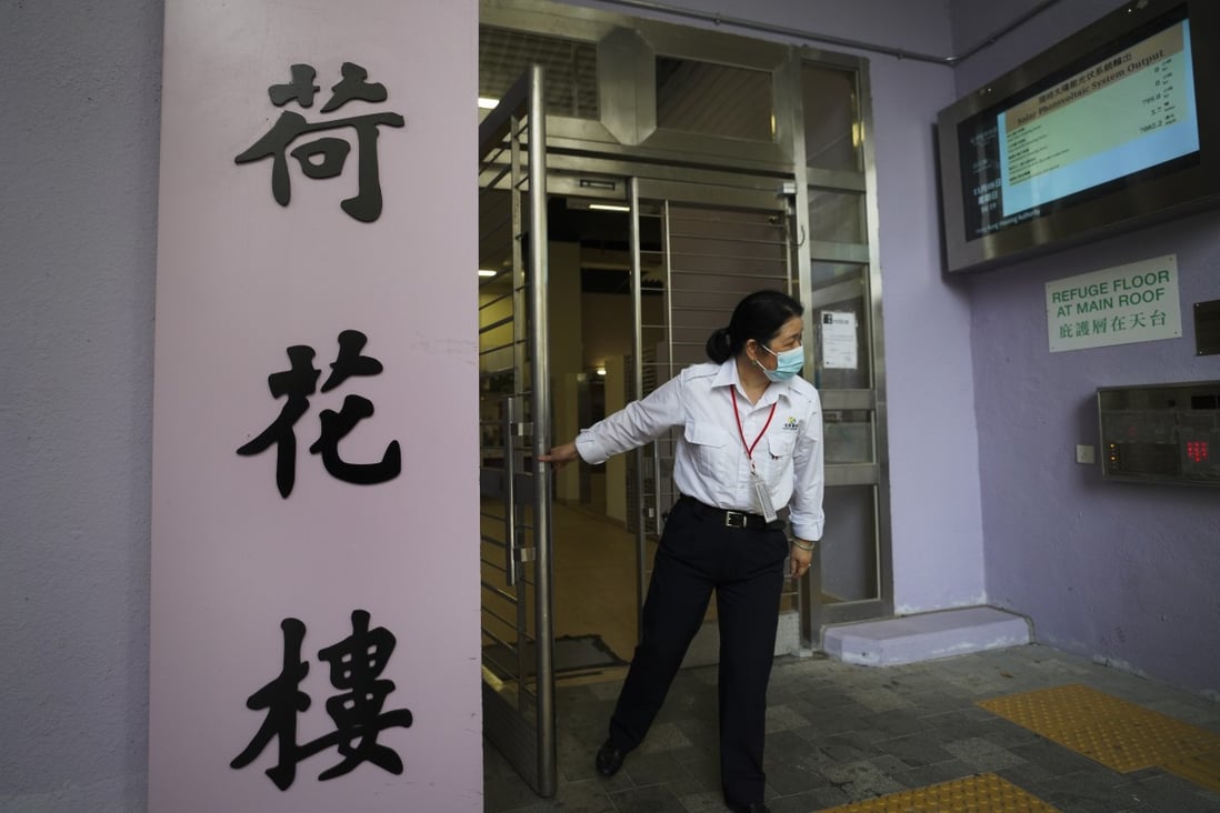 A security guard stands at an entrance to Lotus House at the So Uk public housing estate in Cheung Sha Wan, where a woman and her two children aged six and 10 died after being found in a flat with a gas leak in a suspected murder-suicide on November 8. Photo: Winson Wong