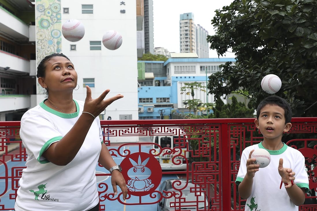 Anik Herawati Liechti and son Max, 8, juggle balls at Po Leung Kuk Lam Man Chan English Primary School in To Kwa Wan. They are part of a pilot project aimed at getting kids to be more physically active. Photo: Xiaomei Chen