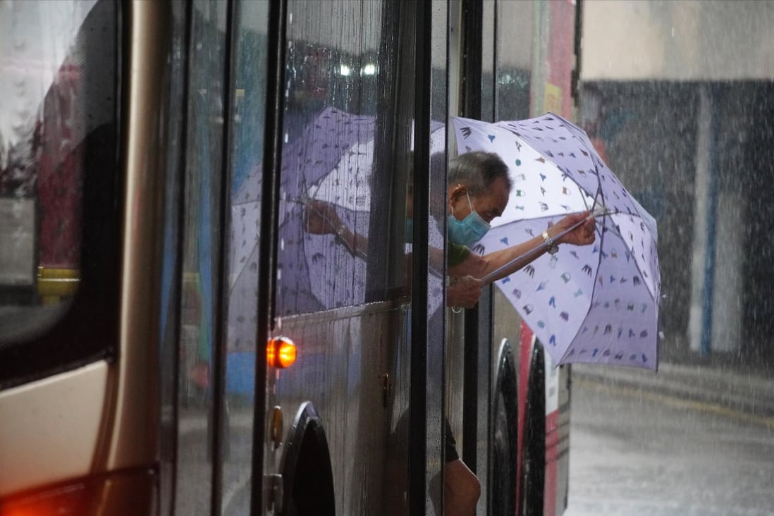 An elderly passenger steps out of a bus into the pouring rain in Tsim Sha Tsui. Hong Kong’s Chief Executive Carrie Lam had announced in January that a scheme allowing people aged above 65 to travel for HK$2 on public transport would be extended to those aged between 60 and 64. Photo: Sam Tsang
