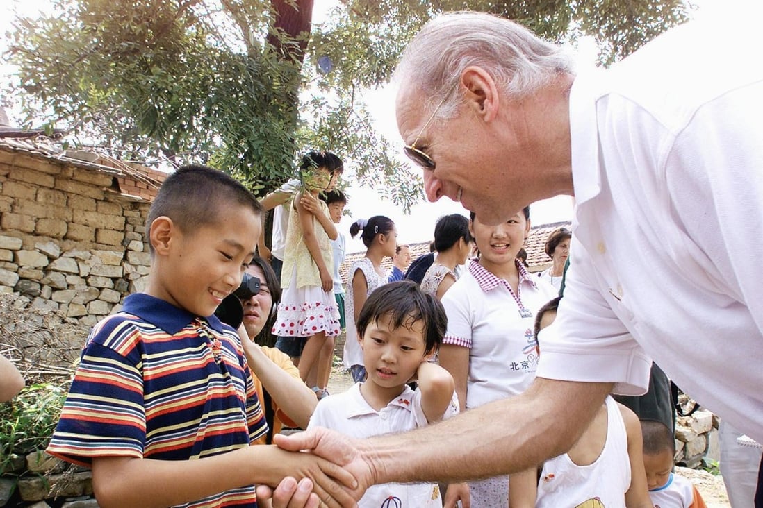 Joe Biden shakes hands with a young Chinese boy in Yanzikou, a village north of Beijing, while chairman of the US Senate foreign relations committee in 2001. Photo: AFP