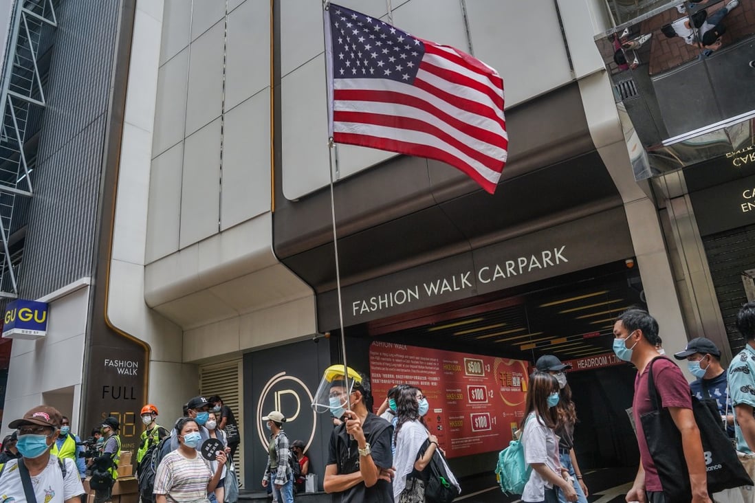 A demonstrator holds a US flag during a protest in Hong Kong on July 1, 2020. Photo: Bloomberg