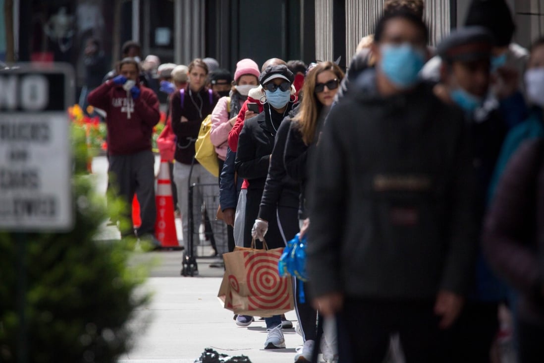 People wearing face masks queue outside a shop amid the coronavirus pandemic in New York earlier this year. Photo: Xinhua