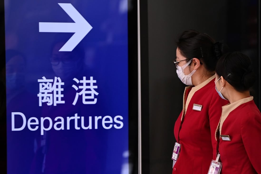 Cathay Pacific employees walk through Hong Kong International Airport on October 21 as the flagship carrier announces mass lay-offs. Photo: AFP