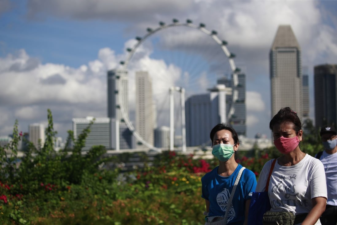 People walk near the central business district of Singapore, one of the world’s richest countries as measured by per capita GDP. Photo: EPA-EFE