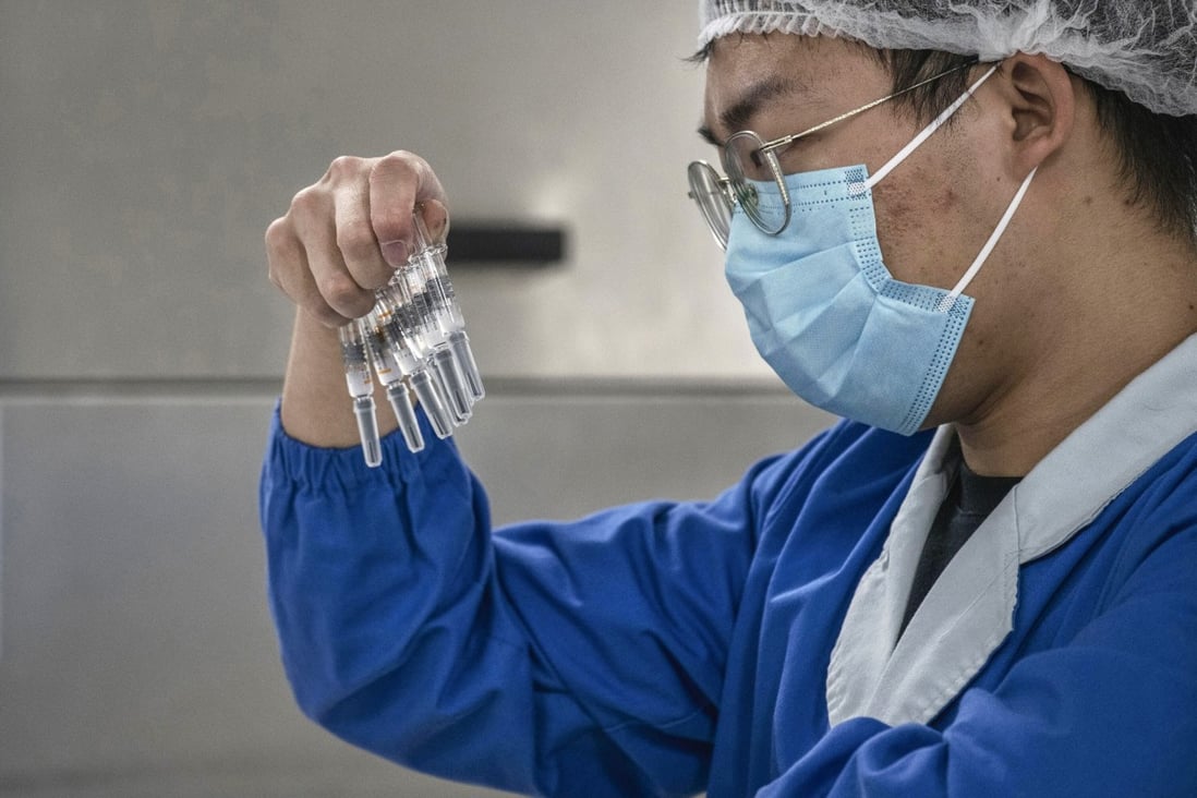 A worker checks syringes on the production line at Sinovac Biotech in Beijing, China. Photo: TNS