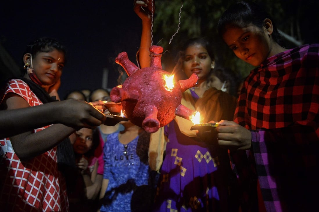 Students prepare to burn a coronavirus model during Diwali, the Hindu Festival of Lights, in Hyderabad, India, on Saturday. Photo: AFP