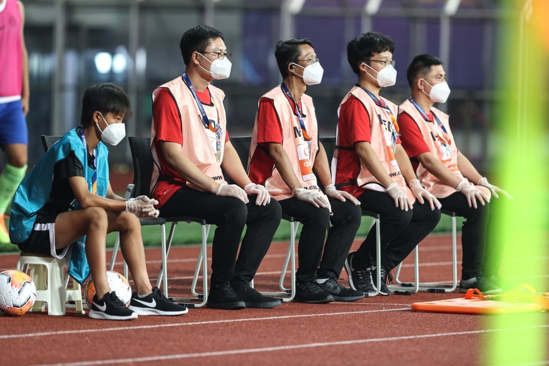 Staff members wearing masks at the opening Chinese Super League match between Wuhan Zall and Qingdao Huanghai in Suzhou in July. Photo: Xinhua
