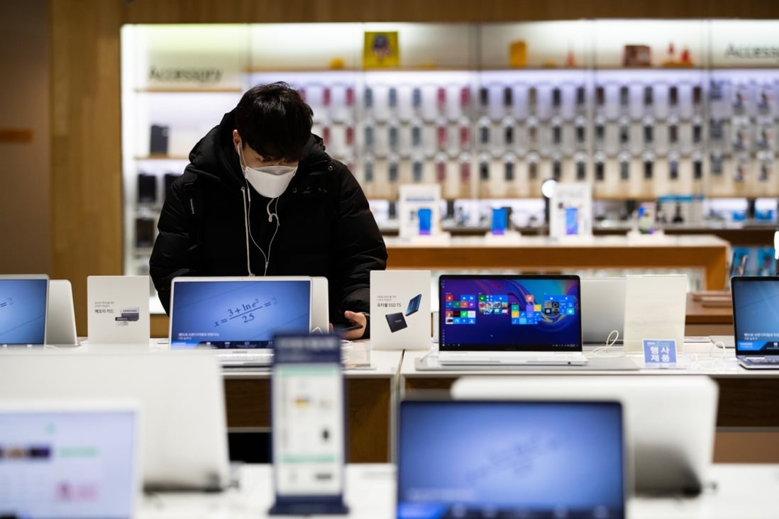 A customer looks at Samsung Electronics laptop computers at the company's flagship store in Seoul, South Korea. Global PC shipments in the third quarter were up 14.6 per cent year on year to 81.3 million units, according to IDC. Photo: Bloomberg
