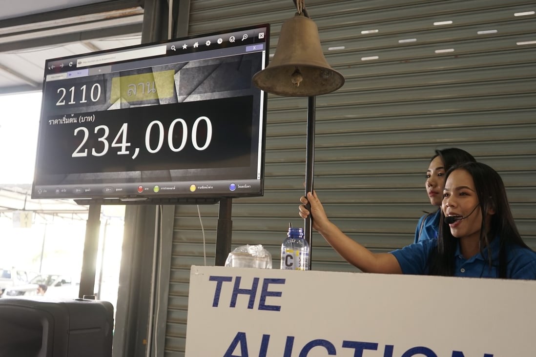 An auctioneer fields bids at the Siam Inter Auto warehouse in Bangkok, where US$1 million worth of second-hand cars were sold in a single day when This Week in Asia visited. Photo: Vijitra Duangdee