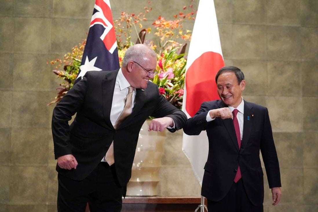 Australian Prime Minister Scott Morrison greets Japanese Prime Minister Yoshihide Suga at Suga's official residence in Tokyo on Tuesday. Photo: Reuters