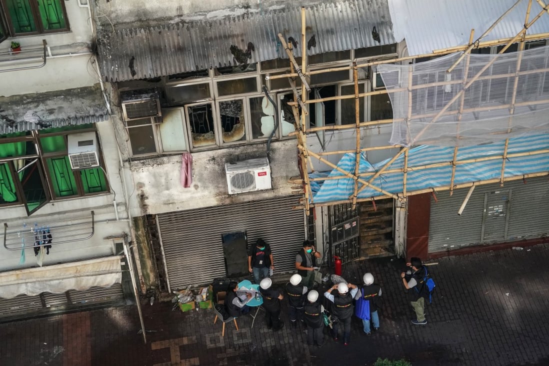 The police and the fire department investigate a fire in which seven people, including a nine-year-old child, were killed and several others critically injured on Sunday night. Photo: Felix Wong