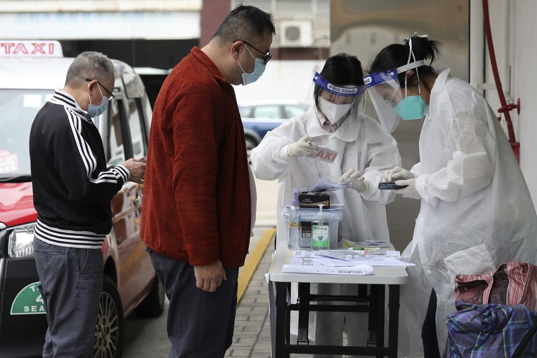 Transport Department workers hand out and collect Covid-19 test kits from taxi drivers, in Chai Wan on November 14. Photo: Xiaomei Chen