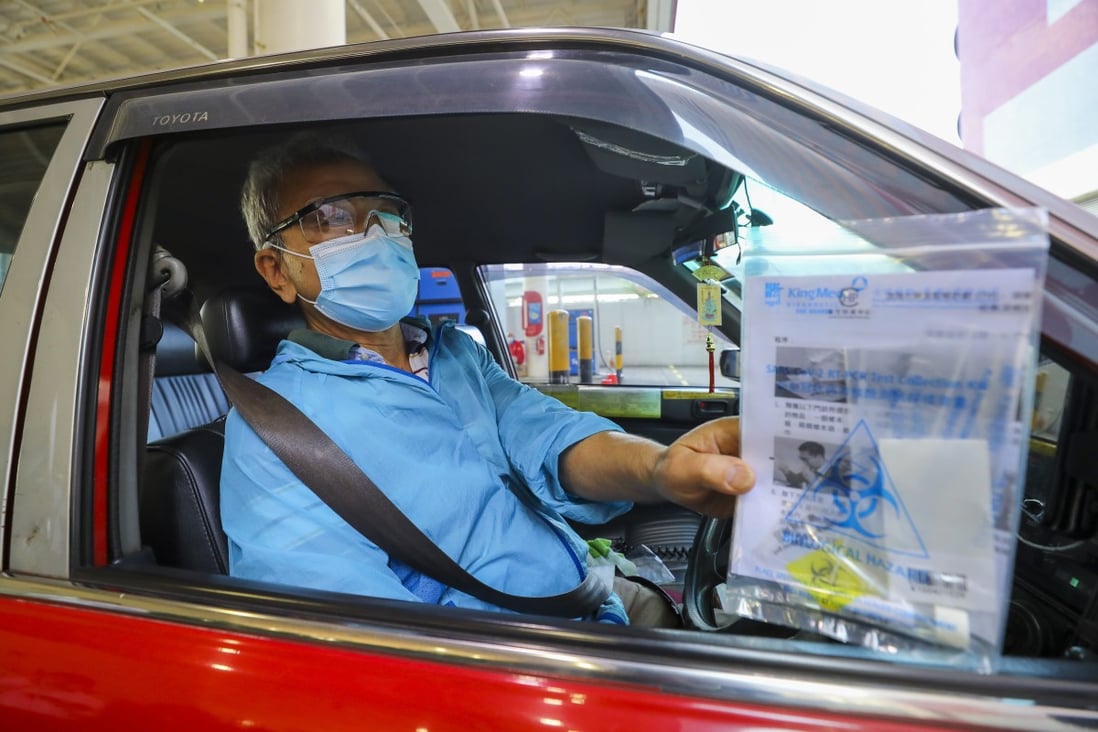 A taxi driver collects a Covid-19 test kit amid fears over the slowly mounting toll of infected cabbies. Photo: Dickson Lee