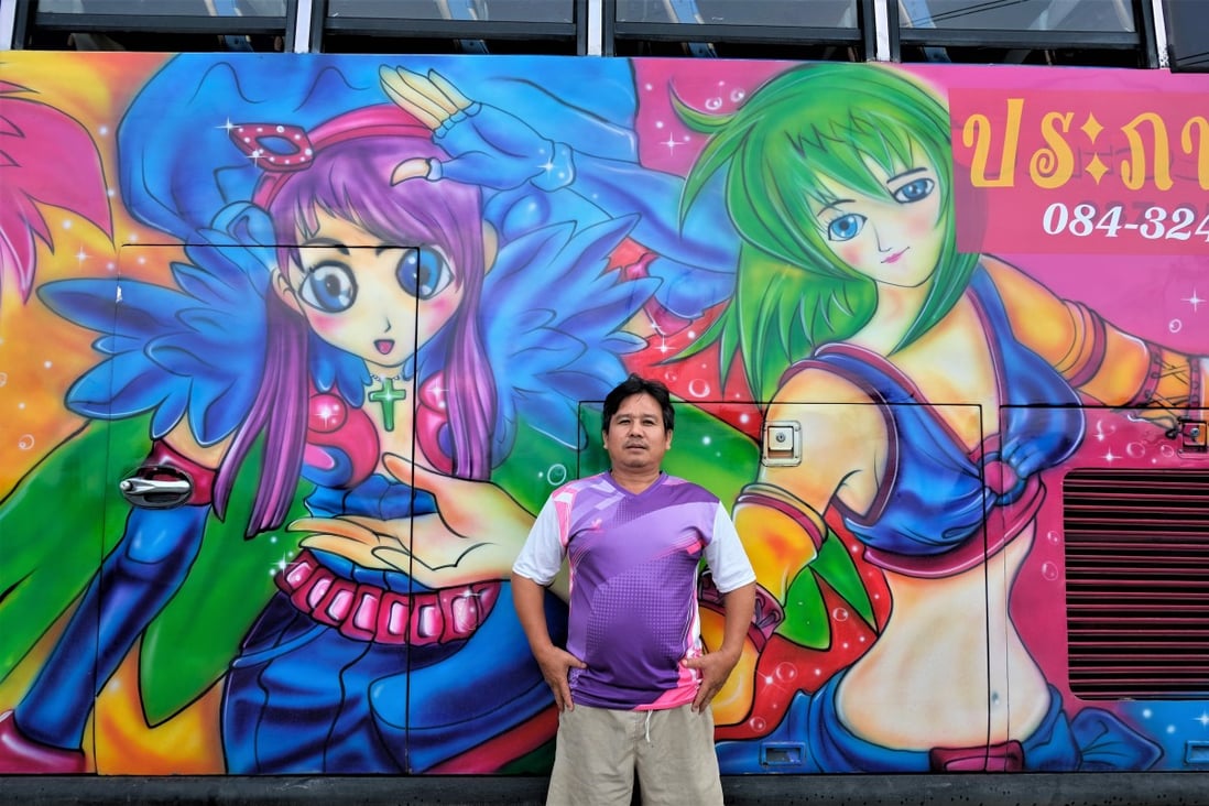 Tour bus driver Prapas Wongchua stands next to his coach decorated with giant anime characters in Nakhon Pathom province, near Bangkok, in Thailand. Photo: Tibor Krausz