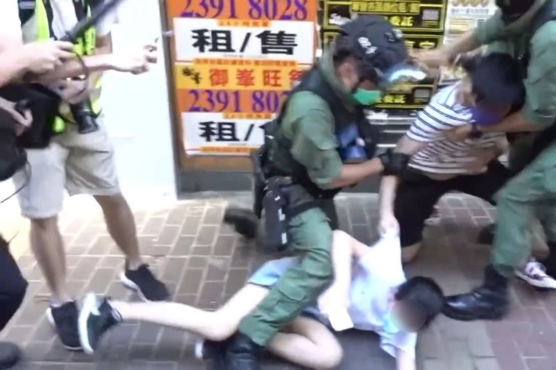 Police officers restrained the girl and her brother during a protest in Hong Kong. Photo: Handout