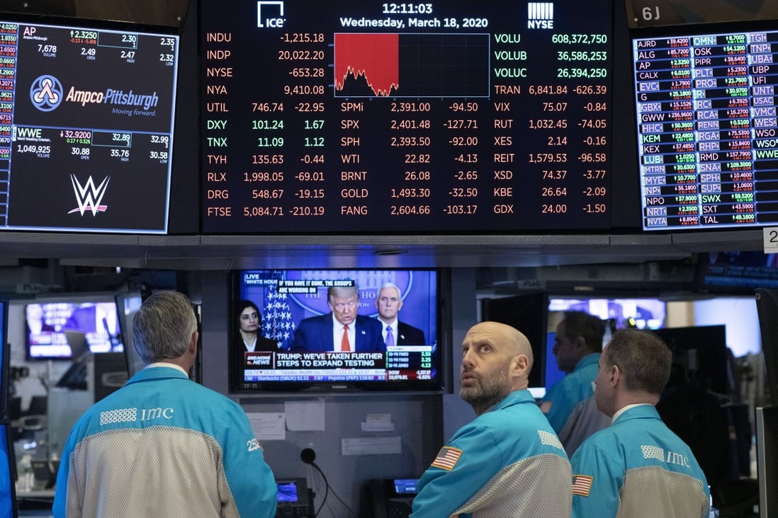Traders at the New York Stock Exchange watch President Donald Trump's televised White House news conference on March 18, 2020. Photo: AP