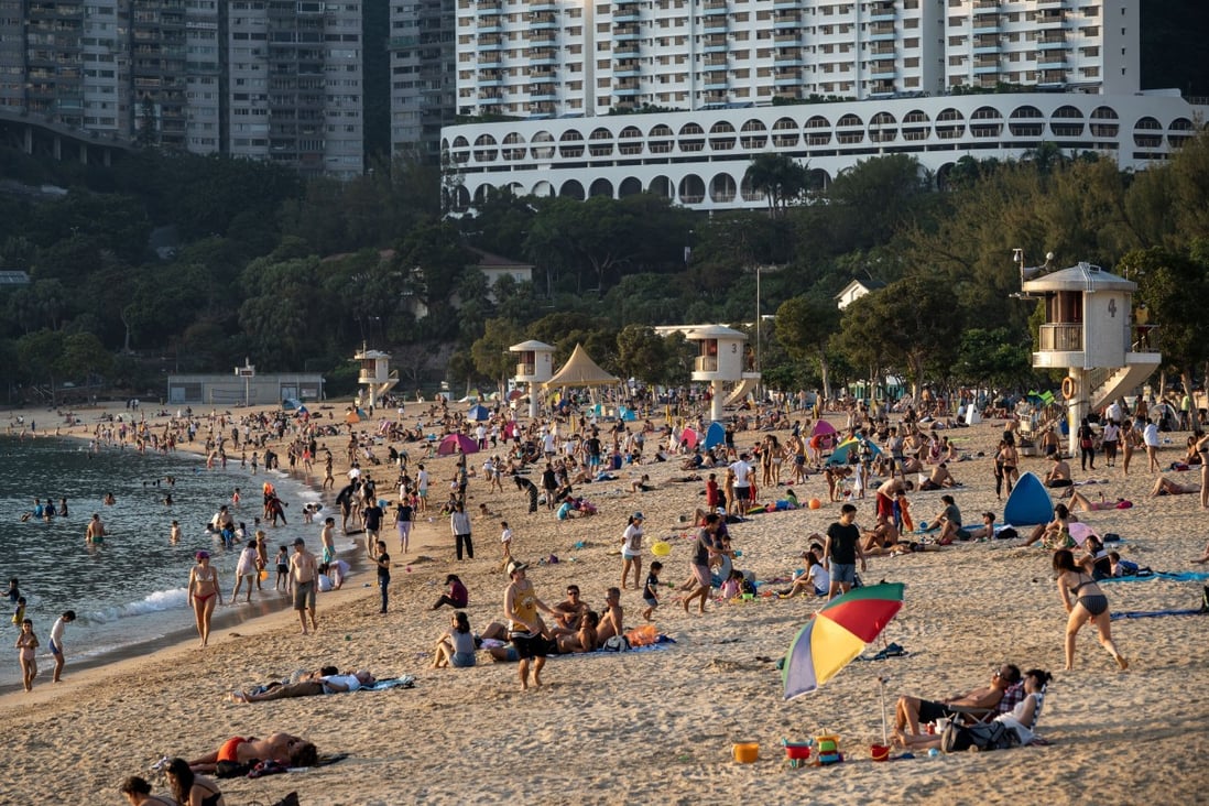 People enjoy time at Repulse Bay beach on November 7. Decisions on whether to go out during the pandemic can seem straightforward, but there are complex forces shaping the world that might be difficult to see at first glance. Photo: DPA