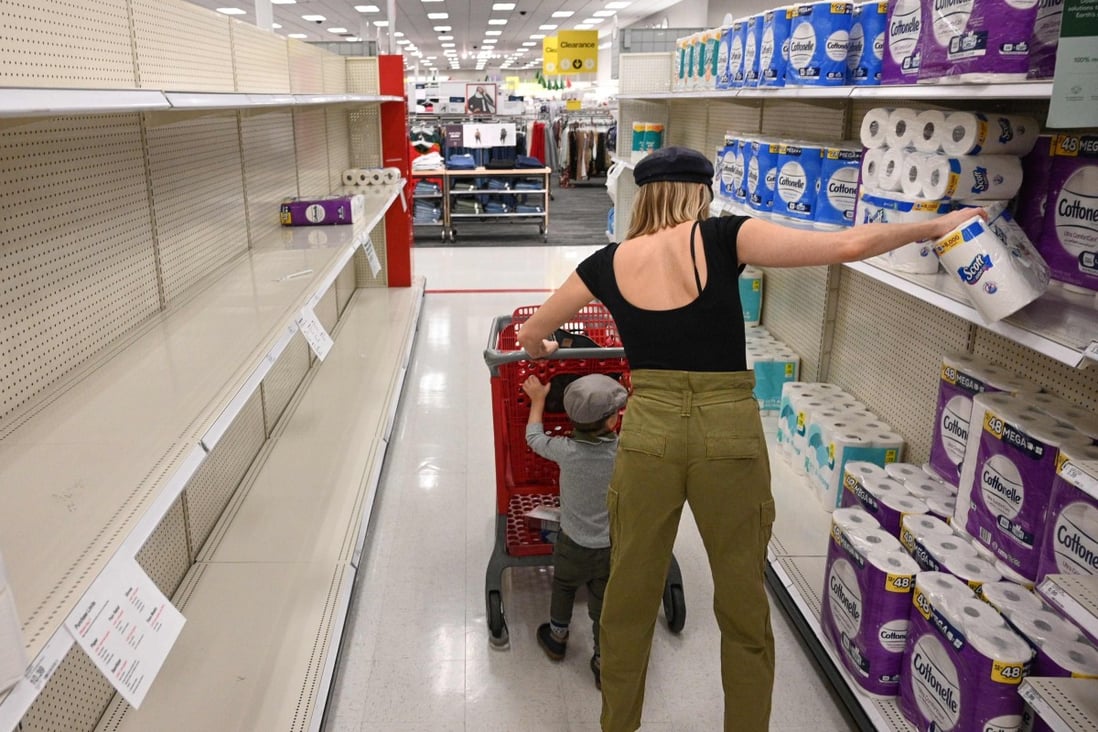 A shopper picks up a roll of toilet paper at a store in Burbank, California. Photo: AFP