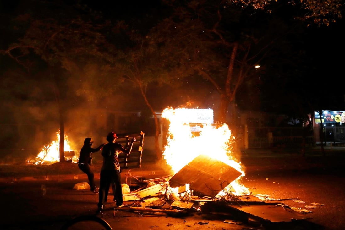 Demonstrators burn objects to block a street during a protest against racism, after Joao Alberto Silveira Freitas was beaten to death by security guards at a Carrefour supermarket in Porto Alegre, Brazil. Photo: Reuters