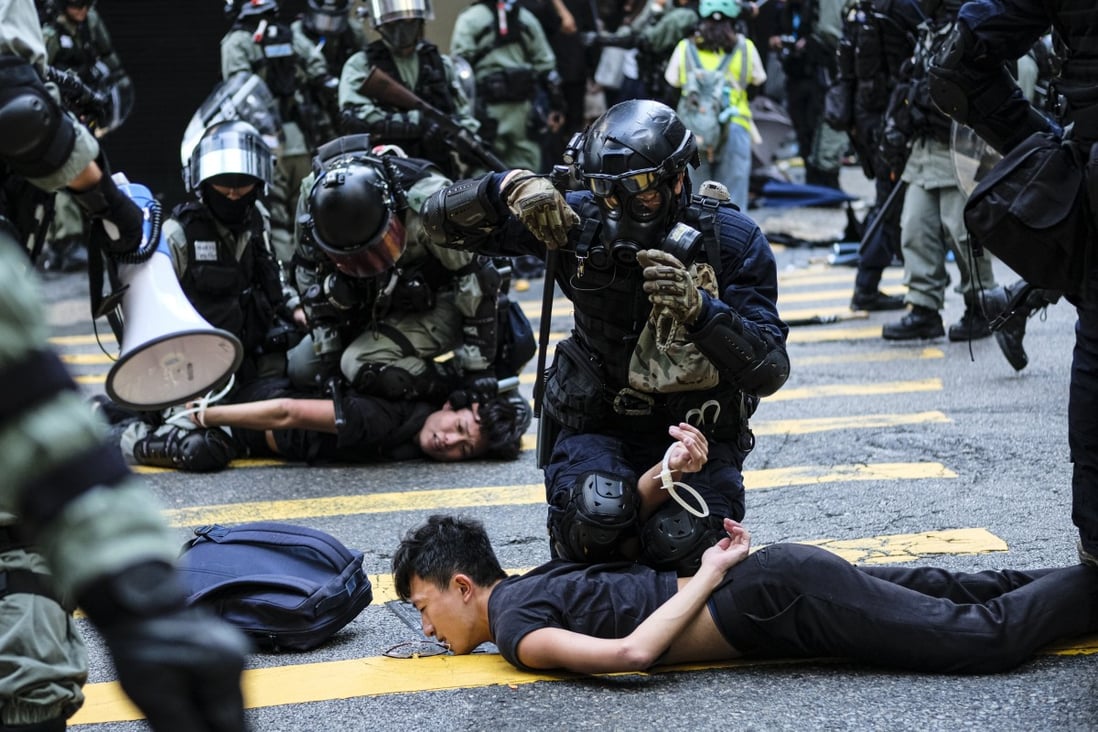 Riot police make arrests during a protest in Central in November of 2019. Photo: DPA