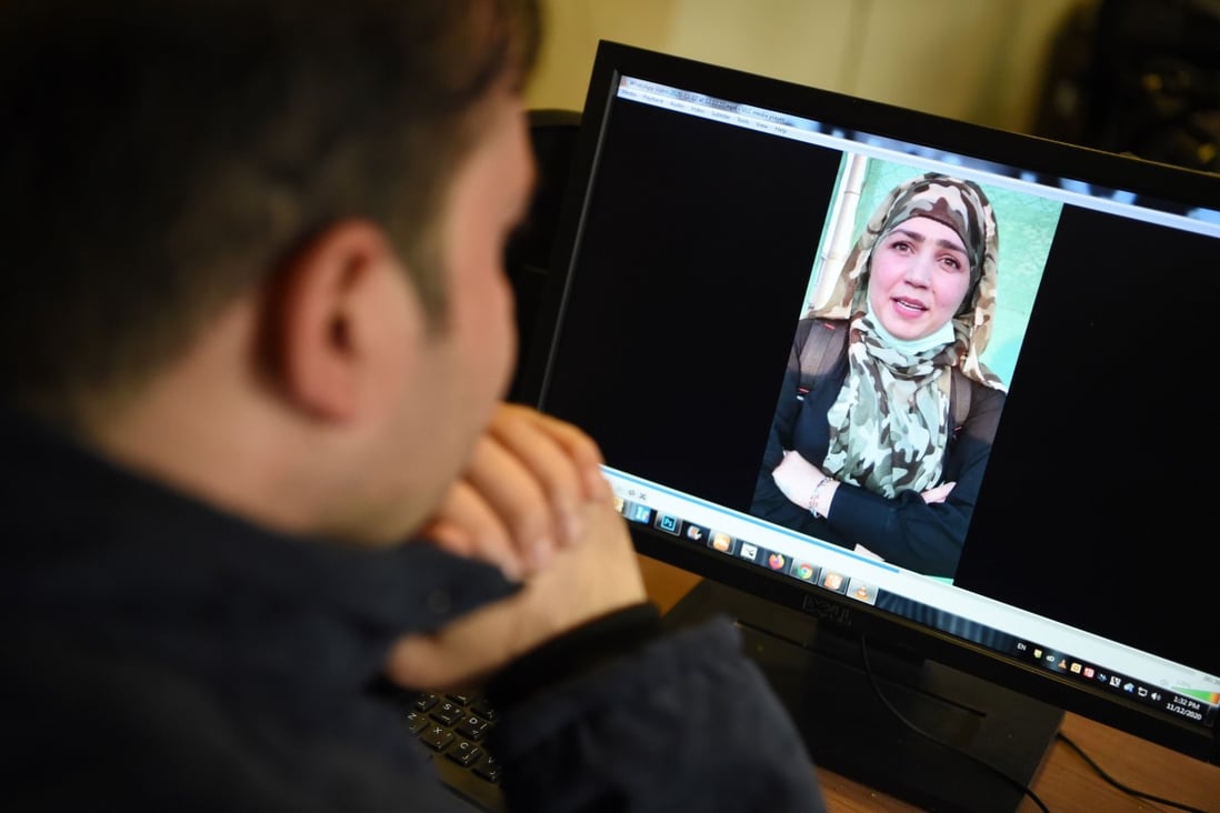 A man watches a video of Muzghan, who walked free from jail in September after confessing to being a member of the Taliban’s Haqqani network. Photo: AFP