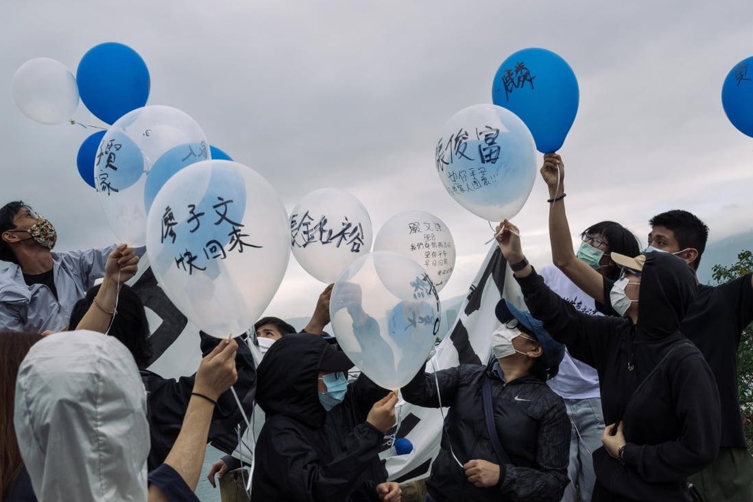 Relatives and supporters of the fugitives release balloons in Kat O, in northeastern Hong Kong across Yantian in Shenzhen, calling for their return. Photo: Bloomberg