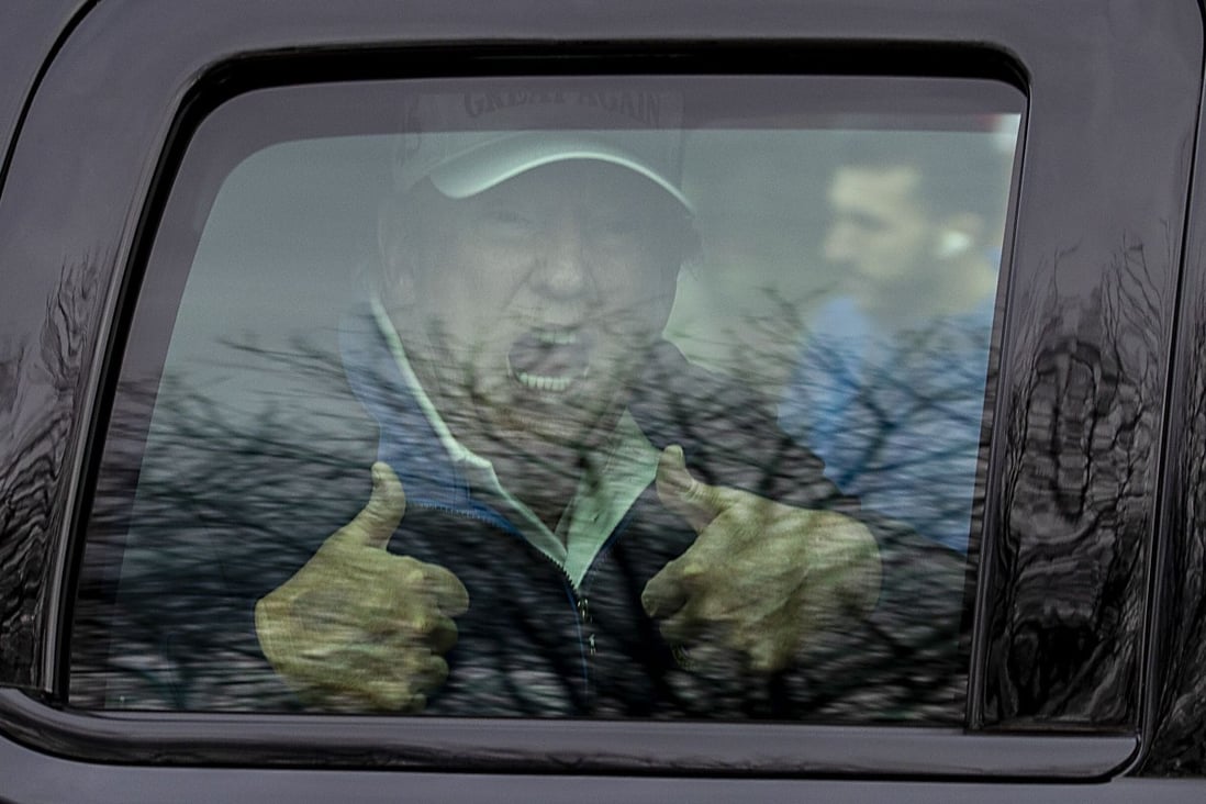 US President Donald Trump gives thumbs up to supporters after playing golf on Sunday. Photo: AFP
